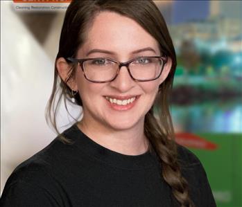 Woman with glasses and long brown hair