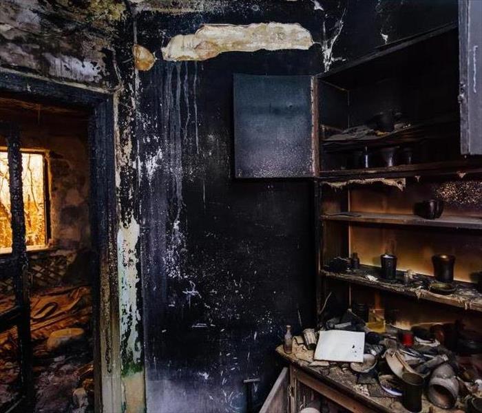 burned furniture, kitchen cabinet, charred walls and ceiling in black soot