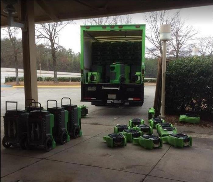 SERVPRO equipment stacked outside under covering